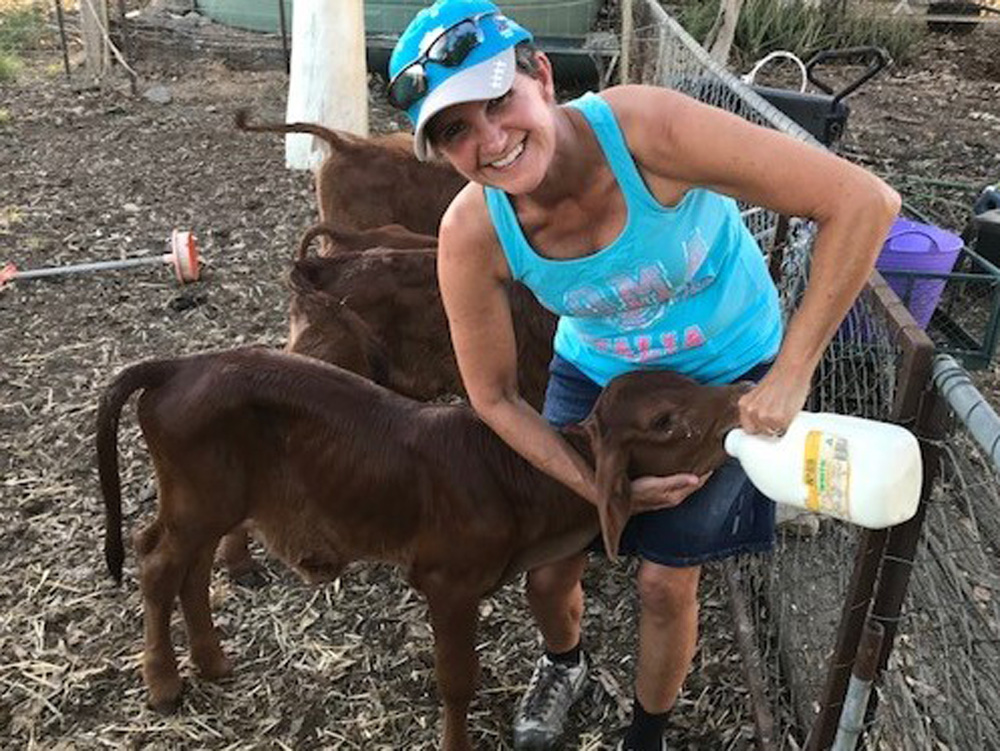 This is a photo of Alice, a BSL Senior Social Worker, at Julia Creek, with her new friend, the local calf